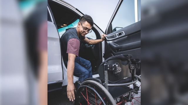 man using wheelchair accessible driving aids